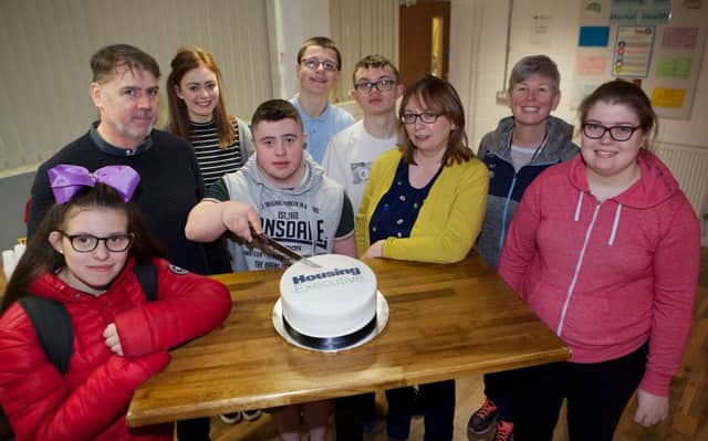 Jack Mooney cutting the cake on behalf of Ardnashee College students who have completed training at 4Rs Recycling. From left are Taylor Healy, Joe Brolly 4Rs Manager, Roisin Keogh 4Rs tutoring assistant, Jack Mooney, Cealan Cleere, Jack Brolly, Joanna OBoyce Housing Executive, Helena Fox, Ardnashee College, and Jennifer Reddin.(Photo - Tom Heaney, nwpresspics)