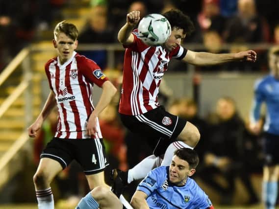 Ciaran Harkin watches on as Derry City skipper, Barry McNamee evades a challenge from Gary O'Neill.
