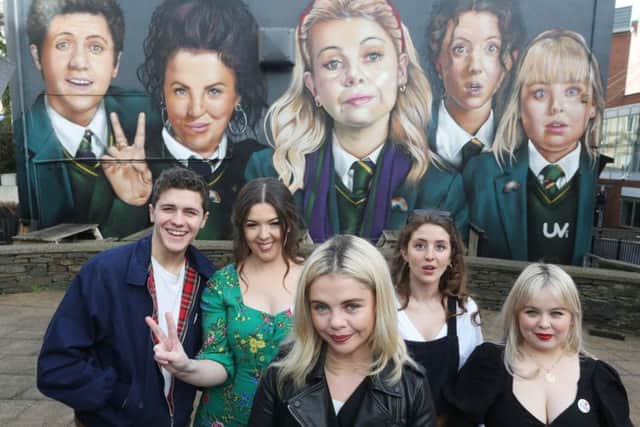 Derry Girls creator Lisa McGee, second from left, pictured yesterday with cast members Dylan Llewellyn, Saoirse-Monica Jackson, Louisa Harland and Nicola Coughlan, when they visited the 'Derry Girls' mural painted by UV Arts at Orchard Street, Derry. The second series of the hit show is coming soon to Channel 4.