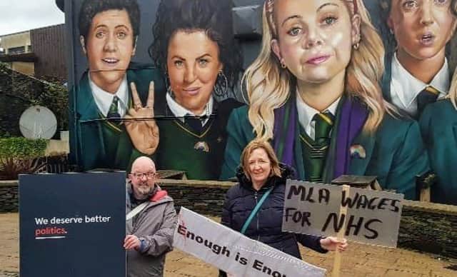 Aideen Hughes with Michael Deery at the Derry Girls poster ahead of the protests this weekend.