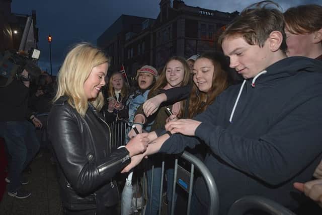 Derry Girls actor Saoirse Jackson autographs a fans arm outside the Omniplex Cinema, Strand Road, on Monday night last, as she arrived for the premiere of Series Two.  DER0819GS-04