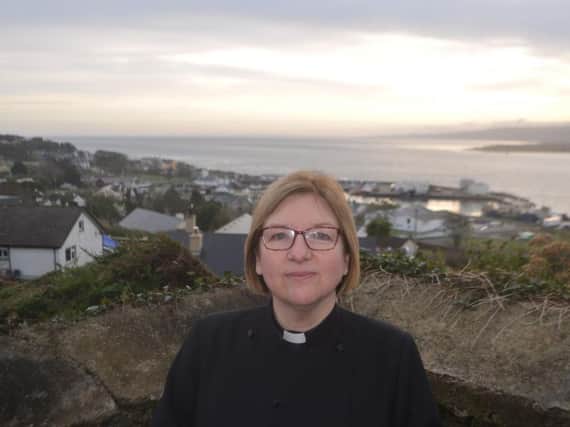 Rev Suzanne Cousins outside St Finian's Church, which overlooks the fishing port of Greencastle in Donegal.