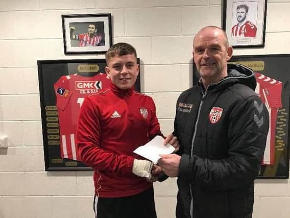 Derry City youngster, Jack Malone receives his Player of the Month award from manager, John Quigg.