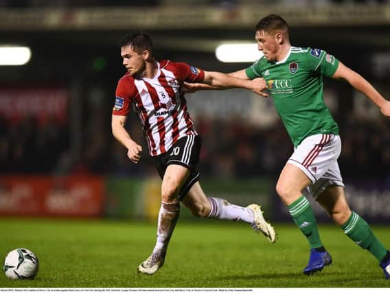 Derry City's Michael McCrudden tussles with Cork City defender Dan Casey.