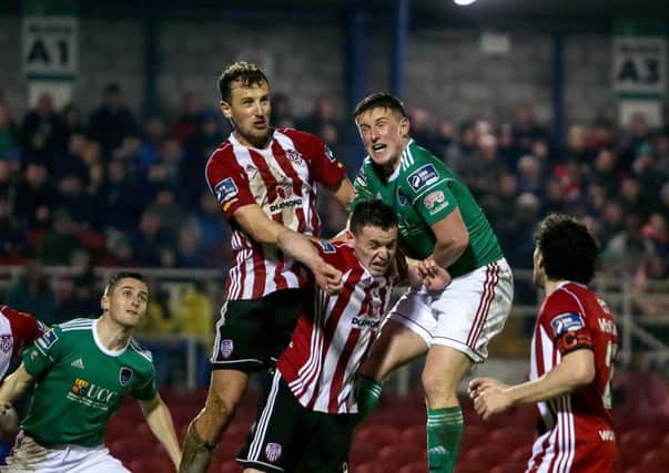 Derry City's Ally Gilchrist wins this towering header before Cork City's Dan Casey, during Friday night's encounter at Turner's Cross.
