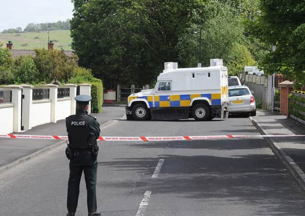 PSNI officers pictured at the scene iin Eglinton yesterday after the home of PSNI officers was targeted when a bomb was left under a car. DER2415MC056
