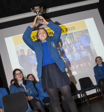 Victorious captain Kate Gallagher holds the Foyle Shield trophy aloft at Monday's Special Assembly at St. Mary's College. (Photo: Jim McCafferty Photography)