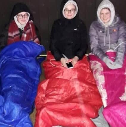 Some of the young people in their sleeping bags outside.