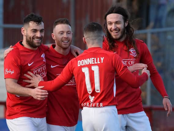 Larne striker, David McDaid celebrates Ben Tilney's goal against Ballinamallard.
