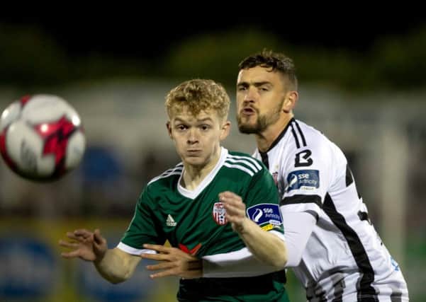 Derry City's Aidy Delap tussles with Dundalk's Dean Jarvis.