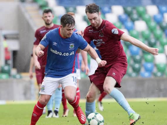 Institute's Colm McLaughlin tussles with Linfield striker Jordan Stewart.