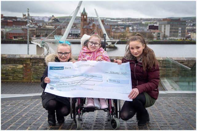 Seanain McCallion, with her sisteres Chloe and Grace, with a cheque for over £9,000 for the Children's Hospice. Pic by Peter McKane.