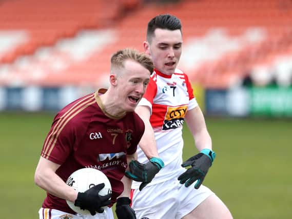 St Patrick's Bramdon Boyd takes on Conor McLaughlin of Cathair Dhoire in the Athletic Grounds on Monday.