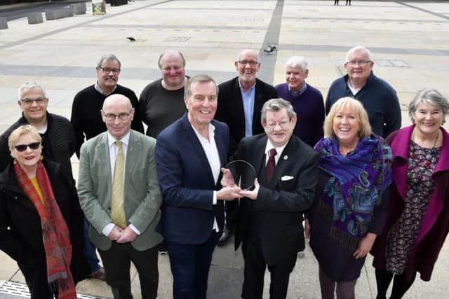 Aidan McKinney, sixth from left, handing over a Veterans' Recognition Award for Lifetime Achievement on behalf of the Northern Ireland Civil Rights Committee to Fionnbarra  Dochartaigh at the Guildhall on Saturday. DER1319-124KM