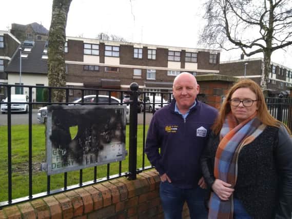 Sharon Duddy with local tour guide Paul Doherty (Bogside History Tours) at one of the badly damaged signs on Rossville Street.