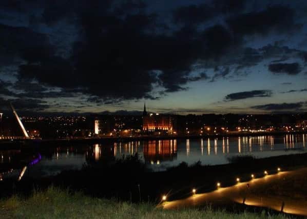 Darkness descends over Derry at night.