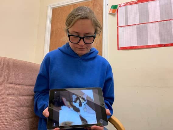 Veronica with a picture of her cat.