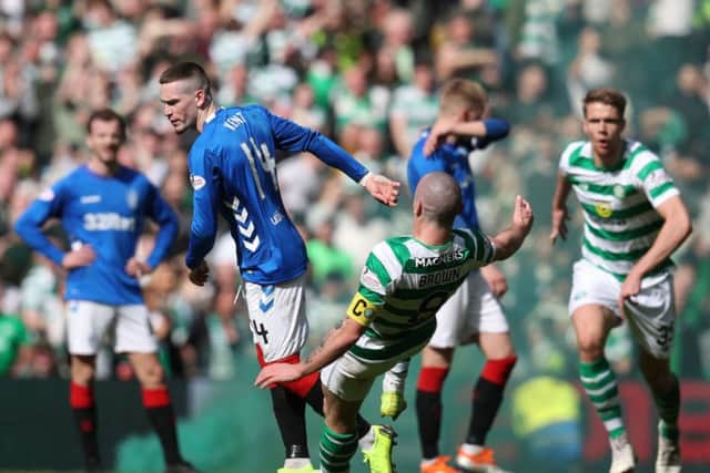 Rangers Ryan Kent (left) and Celtics Scott Brown clash