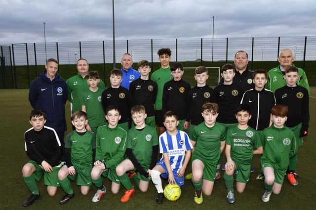 Brighton & Hove Albion academy coach Patrick Rocks, left, pictured with some of the Foyle Harps Youth Football Club players and officials who enjoyed a coaching session at Leafair on Friday evening. DER1419-111KM