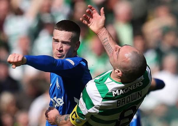 Rangers' Ryan Kent (left) and Celtic's Scott Brown clash