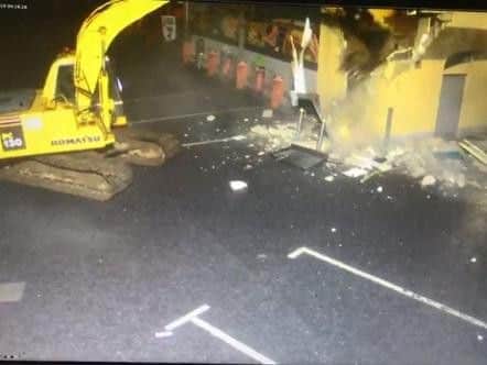 A scene from the CCTV footage captures criminal gang ripping out  ATM machine.