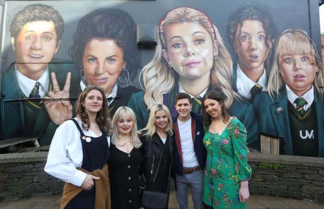 Derry Girls cast members Louisa Harland, Nicola Coughlan, Saoirse-Monica Jackson, Dylan Llewellyn, and creator Lisa McGee when they visited the 'Derry Girls' mural painted by UV Artists on the gable wall of Badger's Bar, Derry. (Photo Lorcan Doherty)