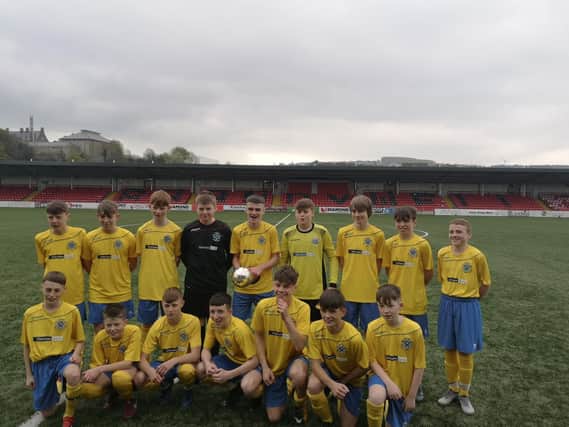 CHAMPIONS . . . St Columb's College U14s lift the Northern Ireland Schools Cup trophy at Brandywell.