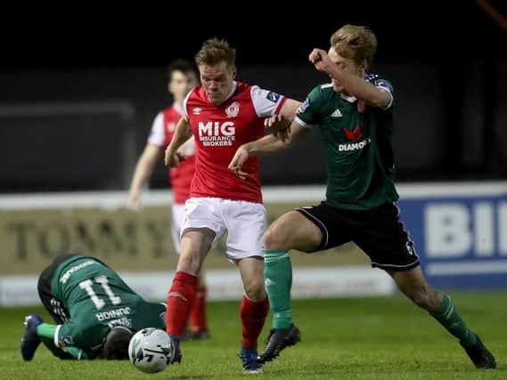 St Patricks Athletic's Simon Madden tussles with Derry City's Greg Sloggett, during their encounter at Richmond Park.