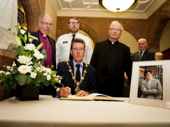 The Mayor of Derry, John Boyle, signing the Book of Condolence for Lyra McKee.
