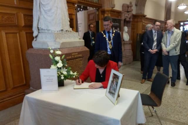 Arlene Foster signs a Book of Condolence in the Guildhall.
