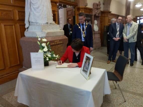 Arlene Foster signs a Book of Condolence in the Guildhall.