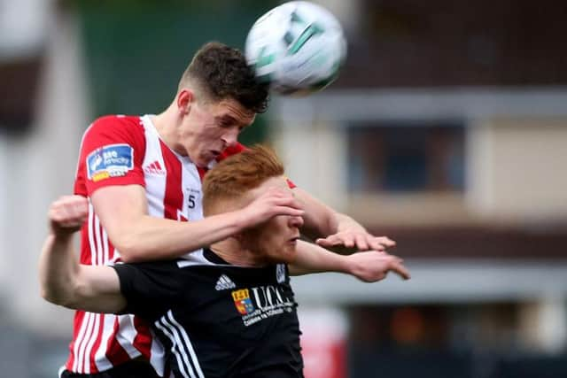 Goalscorer, Eoin Toal rises above Darragh Rainsford to win this header.