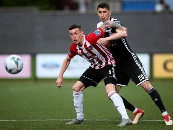 David Parkhouse, pictured holding off Shane Griffin of Cork City on Friday night, will sit out Monday's match against Bohemians through suspension.