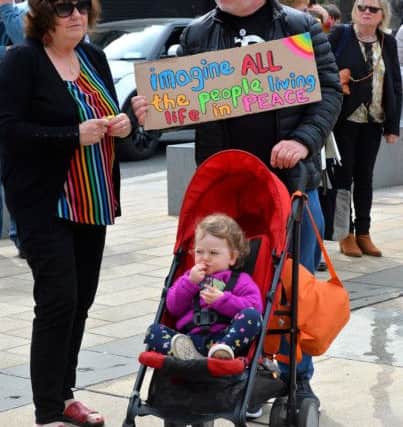 Carmel and Bernard Murray-Gates with their granddaughter Zoe Rutherford at the vigil for Lyra McKee, in Guildhall Square, to express solidarity as her funeral takes place in Belfast.  DER1719GS-032
