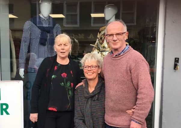 Afke Barr (centre) pictured outside the new John Barr Fashions in Buncrana with her husband John and Dolores McLaughlin, who works in the shop.
