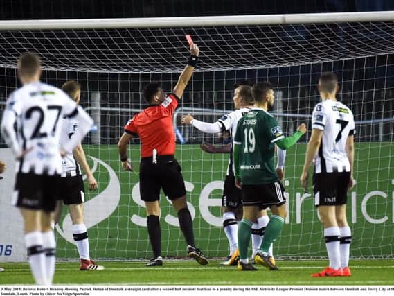 Referee Robert Hennssy showing Patrick Hoban of Dundalk a red card,