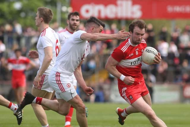 Derry midfielder Padraig Cassidy takes on Tyrone's Richard Donnelly during the Ulster Championship Preliminary Round clash at Healy Park.