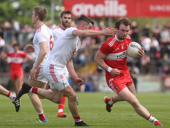 Derry midfielder Padraig Cassidy takes on Tyrone's Richard Donnelly during the Ulster Championship Preliminary Round clash at Healy Park.
