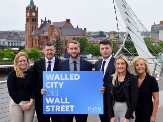 Pictured at the Peace Bridge in Derry are (2nd left) Greg McCann, FinTrU Executive Director & North West Office Site Head with previous FinTrU NW Assured Skills Academy graduates, now FinTrU Analysts (l-r) Jenny Thompson, Damian Faulkner, CJ Martin and Megan Quigley.
