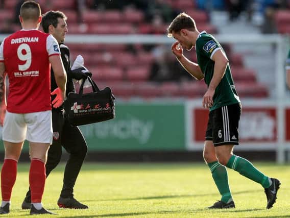 Derry City midfielder, Greg Sloggett leaves the pitch for treatment moments before St Pat's scored.