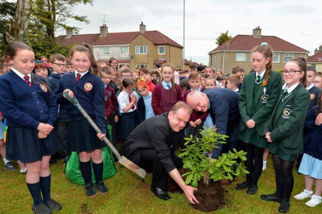 Pupils from Holy Child PS, St Johns PS and St Cecilias College help Fr Joe Gormley and Fr Paul Fraser plant an Oak sapling to commemorate the 60th anniversary of St Marys Church Creggan. DER2219GS-027