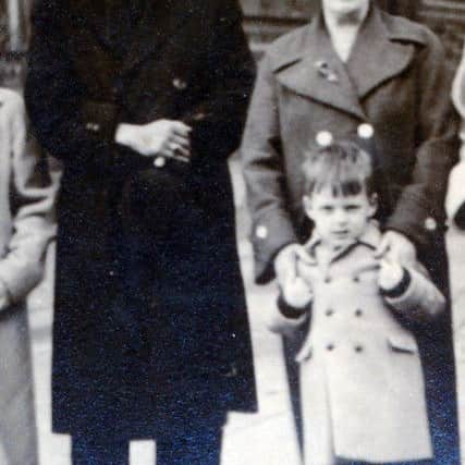 Pictured at Waterside Railway Station on June 9th, 1969 are Dr Pereira with a young Robbie McCarter and Robbie's godmother Agnes Cullen.