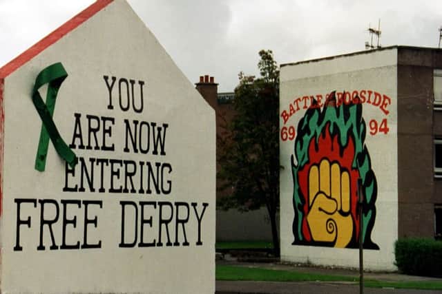 The Battle of the Bogside mural Arlene painted (right) in the 1990s close to Free Derry Corner with the Bogside Artist's mural to the left. (Picture by Hugh Gallagher)