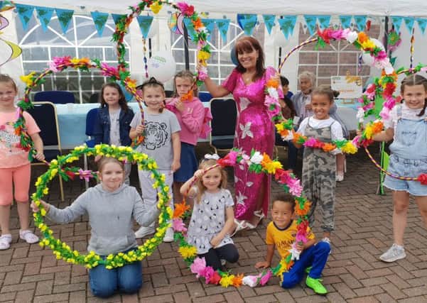 Margaret Cunningham pictured with local children at a previous community event in Hazelbank.