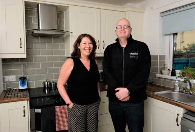 Tenant Joanne McAuley with Neighbourhood Officer, Thomas McDaid in her new kitchen.