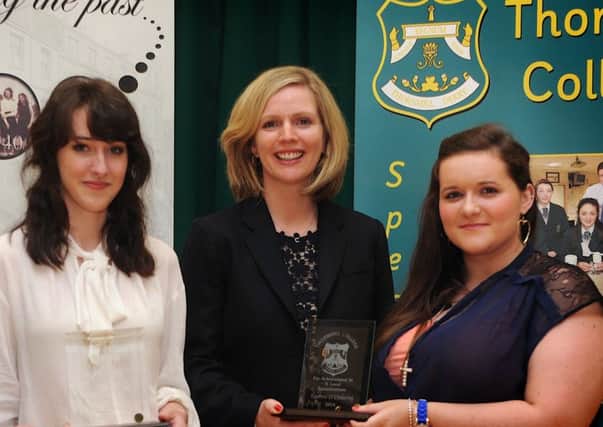 Mrs. Tessa Breslin presenting Charlotte Kenton and Lauren ODoherty with prize-giving awards at Thornhill College during a visit to her alma mater in 2014.