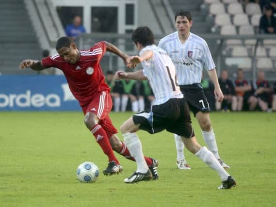 Derry Citys Ruaidhri Higgins and Gareth McGlynn (14), challenge Skonto Rigas Nathan Junior, during their 2009 Europa League tie in the Skonto Stadium.