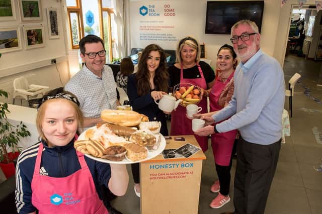 The Tea Room volunteer, Jamielee Mitchell bringa selection of pastries to the tables of the first Honesty Cafe in the Holywell Trust in Brishop's Street where she was joined by the Deputy Mayor, Councillor Cara Hunter, Gerard Deane, Holywell Trust, Lisa Clements, Holywell Trust, Eimear Doherty, volunteer and Jack O'Connor from the Department for Communities.  The cafe which serves breakfast lunch coffee and snacks operates on the principle that people can make a donation for their meal and if possibe a little extra to cover something for people who are less fortunate.Picture Martin McKeown. Inpresspics.com.