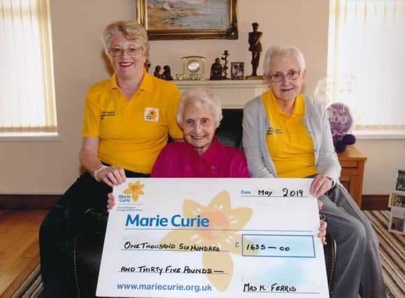 Roberta Bradley & Madge Reid from Marie Curie receiving a cheque for £1,635 from Kathleen Ferris, Limavady for donations on the occassion of her 100th birthday party held recently.