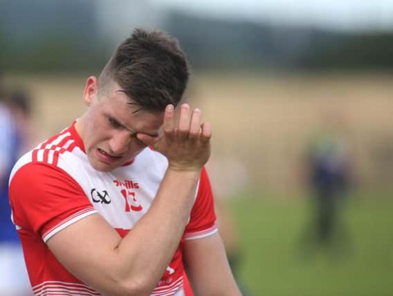 Shane McGuigan is dejected at the final whistle on Saturday in Owenbeg.